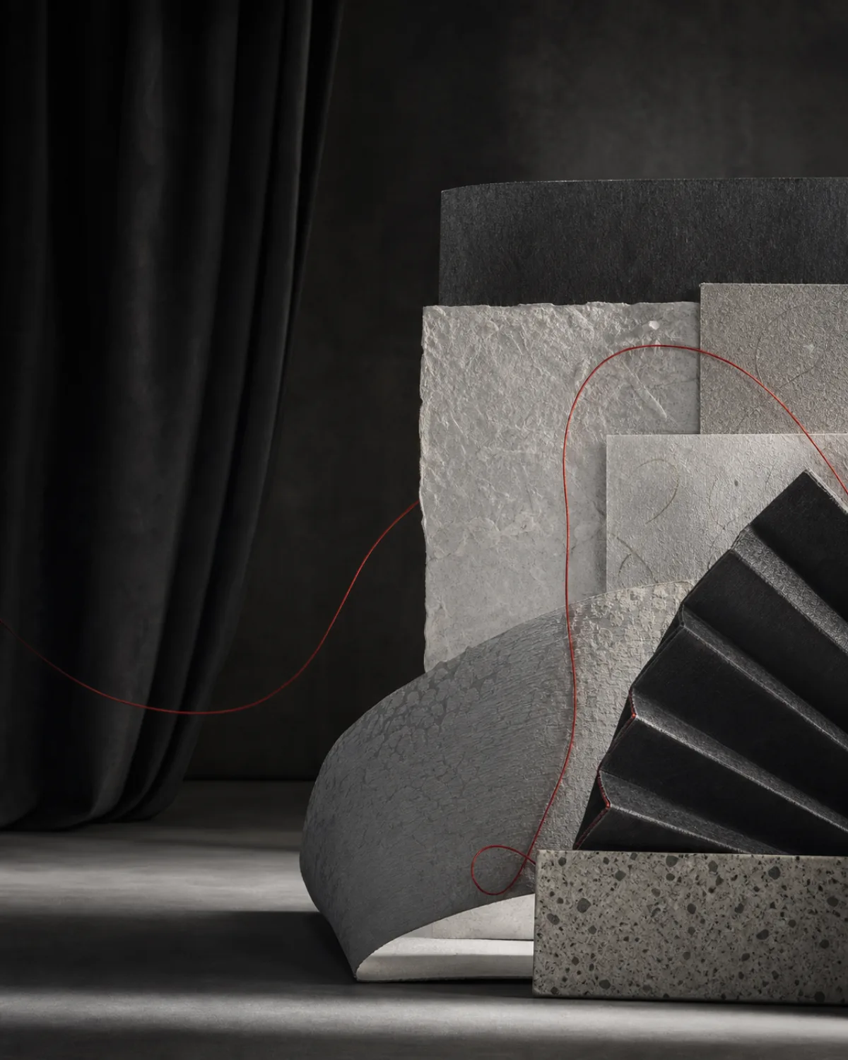 Abstract composition of curtain, paper and a red thread