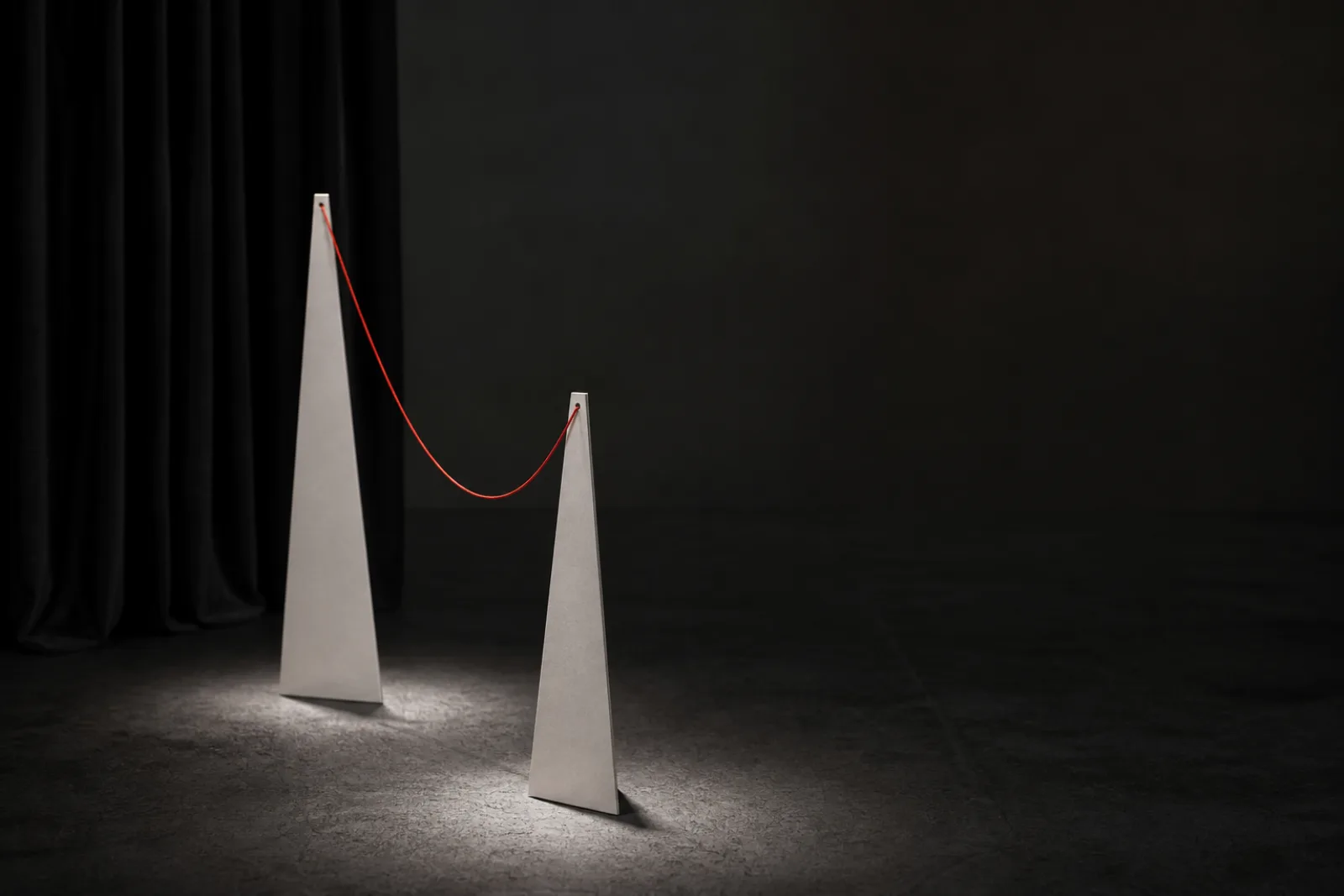 Two paper forms lit on an abstract stage
